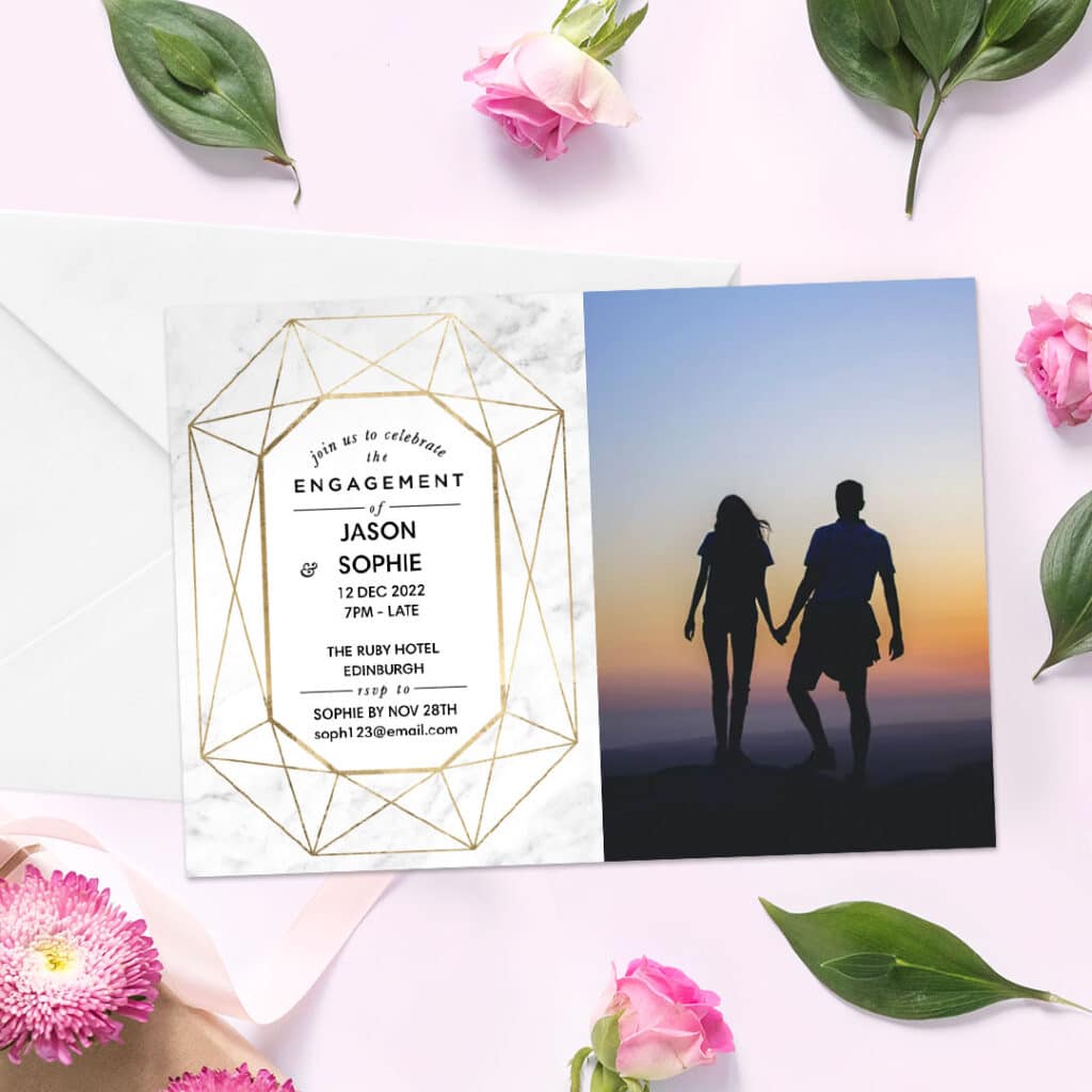 Engagement announcement card displayed on a surface with various pink flowers