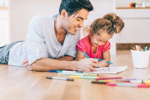 Father and daughter coloring together